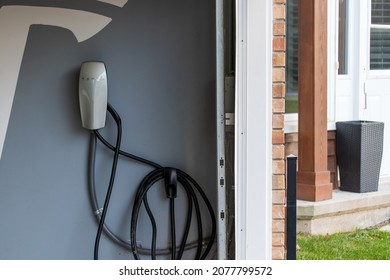 BRANT, CANADA - November 11, 2021:  A Tesla Home Charger Installed Inside A Car Owner's Garage For Their Tesla Electric Vehicle.