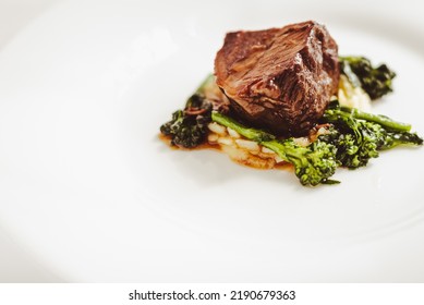 The "brasato al Barolo" is a braised precious roasted beef typical of the Piemonte region, in the north west of italy. Here in a gourmet plating with vegetables.