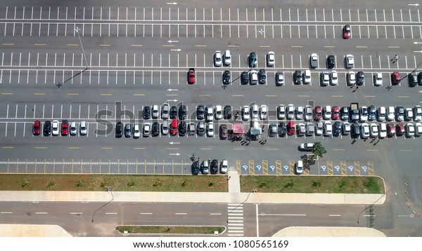 Brasilia Brazil. April 2016. Aerial\
view of a car park as seen from the Digital TV Tower. The image\
shows cars occupying a small portion of the available\
seats.