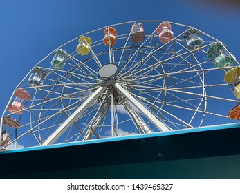 Brasilia, Brazil, July 6, 2019: The Huge Ferris Wheel At Funn Festival 2019, A Symbol Of Fun, At The Largest Winter Festival In The Brazilian Midwest. In The Background The Long Blue Sky.