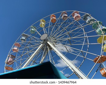 Brasilia, Brazil, July 6, 2019: The Huge Ferris Wheel At Funn Festival 2019, A Symbol Of Fun, At The Largest Winter Festival In The Brazilian Midwest. In The Background The Long Blue Sky.