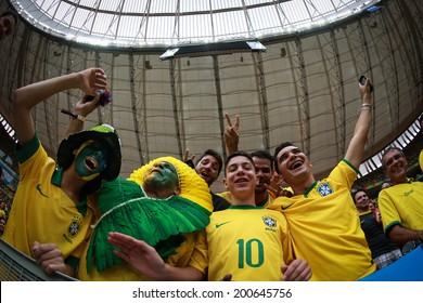BRASILIA, BRAZIL - June 23, 2014: Brazil fans celebrating at the 2014 World Cup Group A game between Brazil and Cameroon at Estadio Nacional Mane Garrincha. No Use in Brazil. - Shutterstock ID 200645756