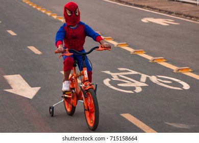 Brasilia, Brazil - September,2017; The Boy In Spider Man Mask Bikes In The Park.