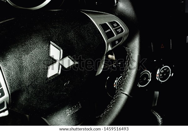 \
Brasilia, Federal District - Brazil. July 23,\
2019. Photo of the interior of a Mitsubishi Lancer GT model 2015\
car. Focus on the brand\
logo.