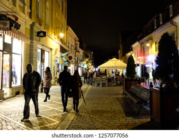 Brasov, Transylvania / Romania - October 11, 2016 : Night Atmosphere At Old Town Center In Autumn, Couple Walking Together.