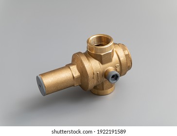 Brass accessories for water supply, water supply and irrigation: pressure gauge, fittings, on a light gray background