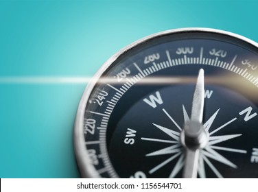 Brass antique compass on blue background - Shutterstock ID 1156544701