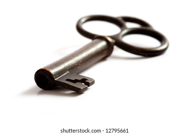 A Brass, Antique Skeleton Key On A White Background