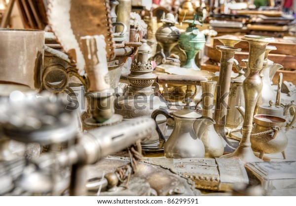 Brass antiques at a market stall. High dynamic\
range image.