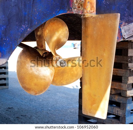 brass boat propeller and steering in beached ship