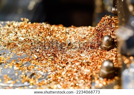 Brass and bronze shavings on a lathe after processing non-ferrous metals.