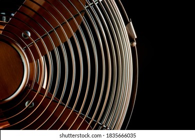 Brass Desk Fan Section Isolated Against A Black Background