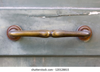 A Brass Door Handle On A Wooden Blue Door