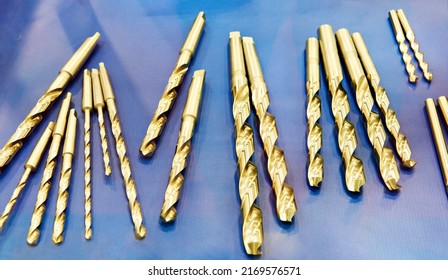 Brass drills on blue background - Shutterstock ID 2169576571