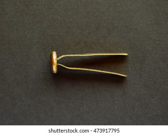 Brass Fastener, Brad, Paper Fastener Or Split Pin Over Black Background