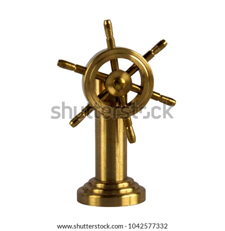 Brass figurine or miniature of vintage ship wheel isolated on white background