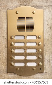 Brass intercom on a marble facade