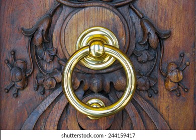 Brass Knocker In A Wooden Door