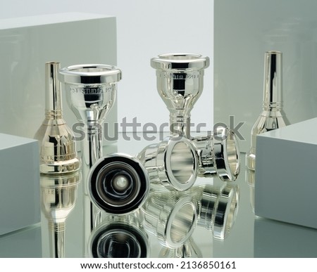 brass mouthpieces on shiny surface