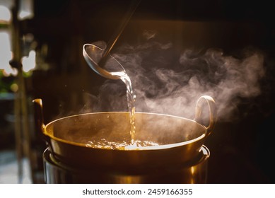 A brass pot is steaming while the chef cooks desserts using a ladle to stir in the brass pot.