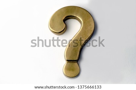 A brass question mark