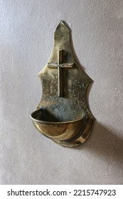 A Brass Stoup For Holy Water Hanging In The Vestibule Of The Church.