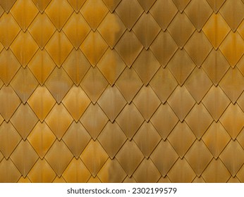 Brass tiles on a facade in Lugano, Switzerland. The pattern, texture repeats itself indefinitely.