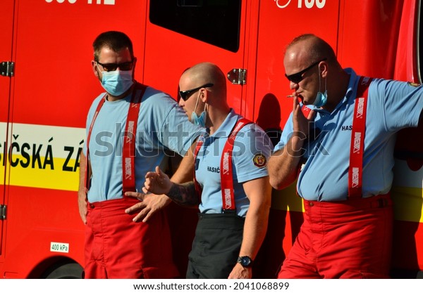 BRATISLAVA, September\
13th 2021 - A group of firefighters taking a break next to their\
fire truck while waiting for the next steps during the visit of\
Pope Francis to\
Slovakia.
