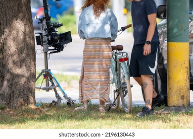 Bratislava, Slovakia - 24 August 2022: Woman Near The White Vintage Bicycle And Film Camera In The Park.