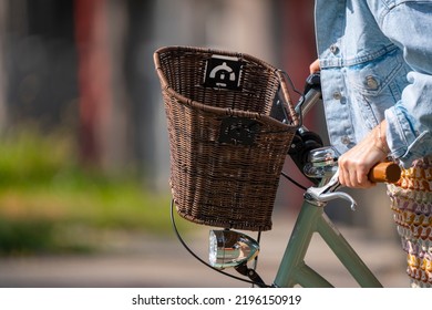 Bratislava, Slovakia - 24 August 2022: Selective Focus Of Handlebar And Wicker Basket Of Woman Bicycle.