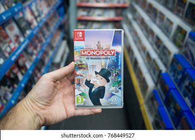 Bratislava, Slovakia, December 2, 2017: Man Holding Monopoly Videogame On Nintendo Switch Console In Store