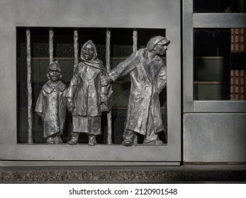 Bratislava, Slovakia - February 09 2022: Mini Sculpture Of A Historic Family With A Child At The Bottom Of A Metal Front Door, Kulich 1983