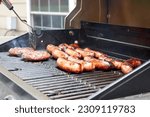 Brats and burgers on a hot grill