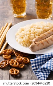 Bratwurst sausage ,sauerkraut, pretzels and beer on wooden table. typical german food	