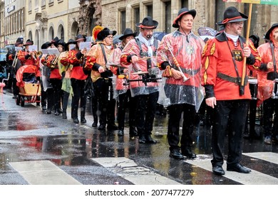 Braunschweig, Germany, February 23, 2020: Fanfare from People with black hats in rain clothes at the carnival in the city center