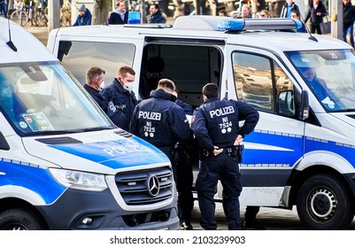 Braunschweig, Germany, January 8, 2022: Group Of Male Police Officers Debriefing At Police Van With Side Door Open