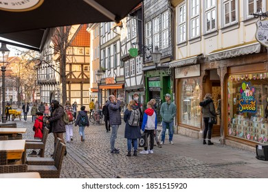 Braunschweig, Germany - Nov 7th 2020: Amount Of People Allowed To Stores Is Limited Because Of Coronavirus Pandemic. People Stand In Line Outside A Candy Store Waiting To Get In.