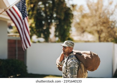 Brave American Soldier Walking Towards His House With His Luggage. Patriotic Young Serviceman Coming Back Home After Serving His Country In The Military.