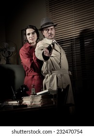 Brave Detective Pointing A Gun And Young Scared Woman Hiding Behind Him, 1950s Film Noir Style.