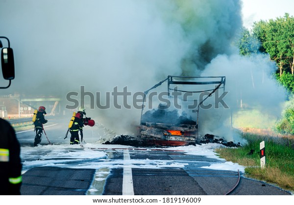 brave firefighter puts out the fire car,\
firefighter putting out a car that was\
burning