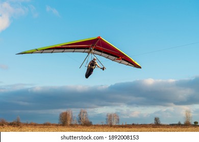 Brave girl student is mastering hang gliding sport. Extreme sports activity