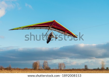 Brave girl student is mastering hang gliding sport. Extreme sports activity Stock photo © 