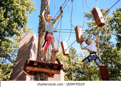 Brave kids climbs in rope park, playground - Powered by Shutterstock