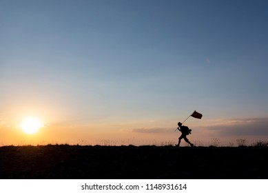 Brave Mountaineer Carrying The Flag On Top