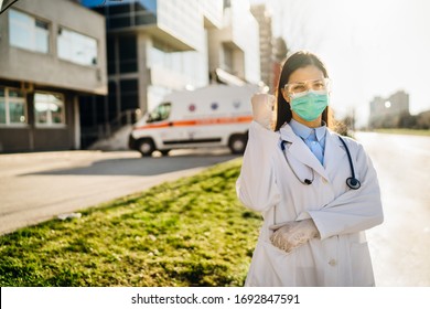 Brave Optimistic Paramedic In The Front Lines,working In A Isolation Hospital Facility With Infected Patients.Covid-19 Emergency Room Triage Doctor With Protective Glasses / Mask.Fighting Coronavirus