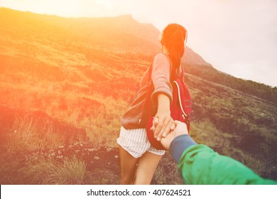 Brave and romantic adventure woman guiding man into the wild (intentional sun glare and vintage color) - Shutterstock ID 407624521