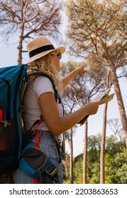 Brave Woman Explores With Her Map In The Middle Of The Savannah, Vertical Shot