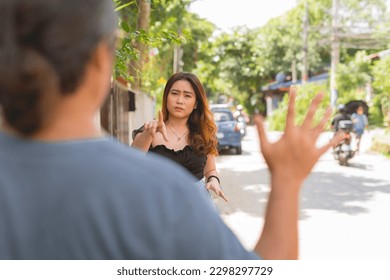 A brave young asian woman confronts a creepy stalker following her while walking. Courageously standing up to harassment.