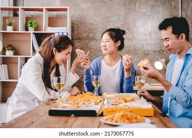 Bravo! A Group Of Cheerful Young People Enjoy Food And Drink Together In The Office.