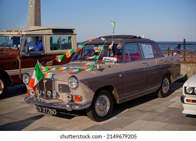 BRAY, CO. WICKLOW, IRELAND - MARCH 19, 2022: Classic Wolseley 15-60 From 1960s With Four Door Decorated With Irish Flags At The Bray Vintage Car Club Show. Annual Open Air Retro Cars Display.